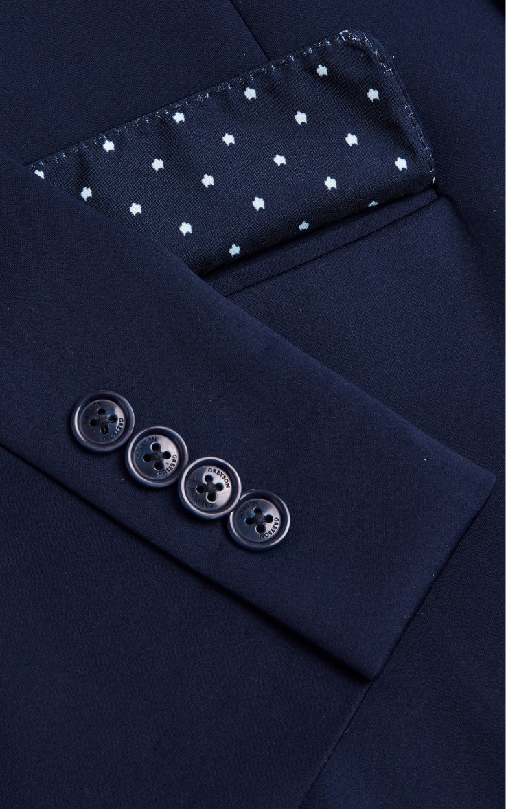 close up shot of pocket and sleeve of navy blue blazer